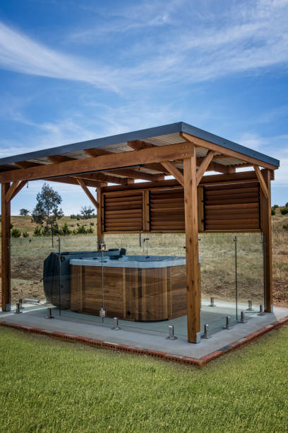 Stained cedar pergola with hot tub in Lubbock TX backyard